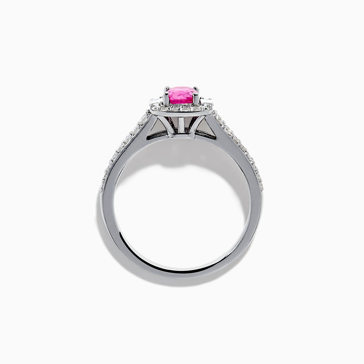 The 14K White Gold Pink Sapphire and Diamond Halo Ring showcases a vivid oval pink sapphire, encircled by a diamond halo with extra diamonds set along its elegant double band.