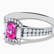 The 14K White Gold Pink Sapphire and Diamond Halo Ring showcases a vivid oval pink sapphire, encircled by a diamond halo with extra diamonds set along its elegant double band.