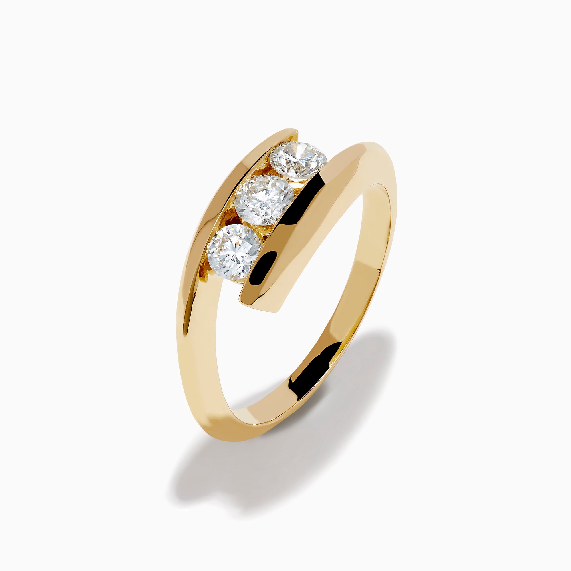 The D'Oro 14K Yellow Gold Diamond Bypass Ring features three round white diamonds in a row and a modern, open, curved band design, shown on a white background.