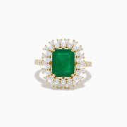 The 14K Yellow Gold Emerald and Diamond Halo Cocktail Ring showcases a large rectangular green emerald at the center, surrounded by a sparkling double halo of round white diamonds.