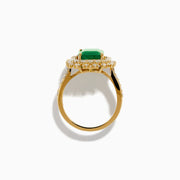 The 14K Yellow Gold Emerald and Diamond Halo Cocktail Ring showcases a large rectangular green emerald at the center, surrounded by a sparkling double halo of round white diamonds.