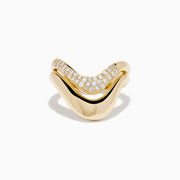 The 14K Yellow Gold Diamond Sculptural Ribbon Ring features a wavy V-shaped design with a sparkling diamond ribbon band above a polished gold band, creating an elegant two-layer look.