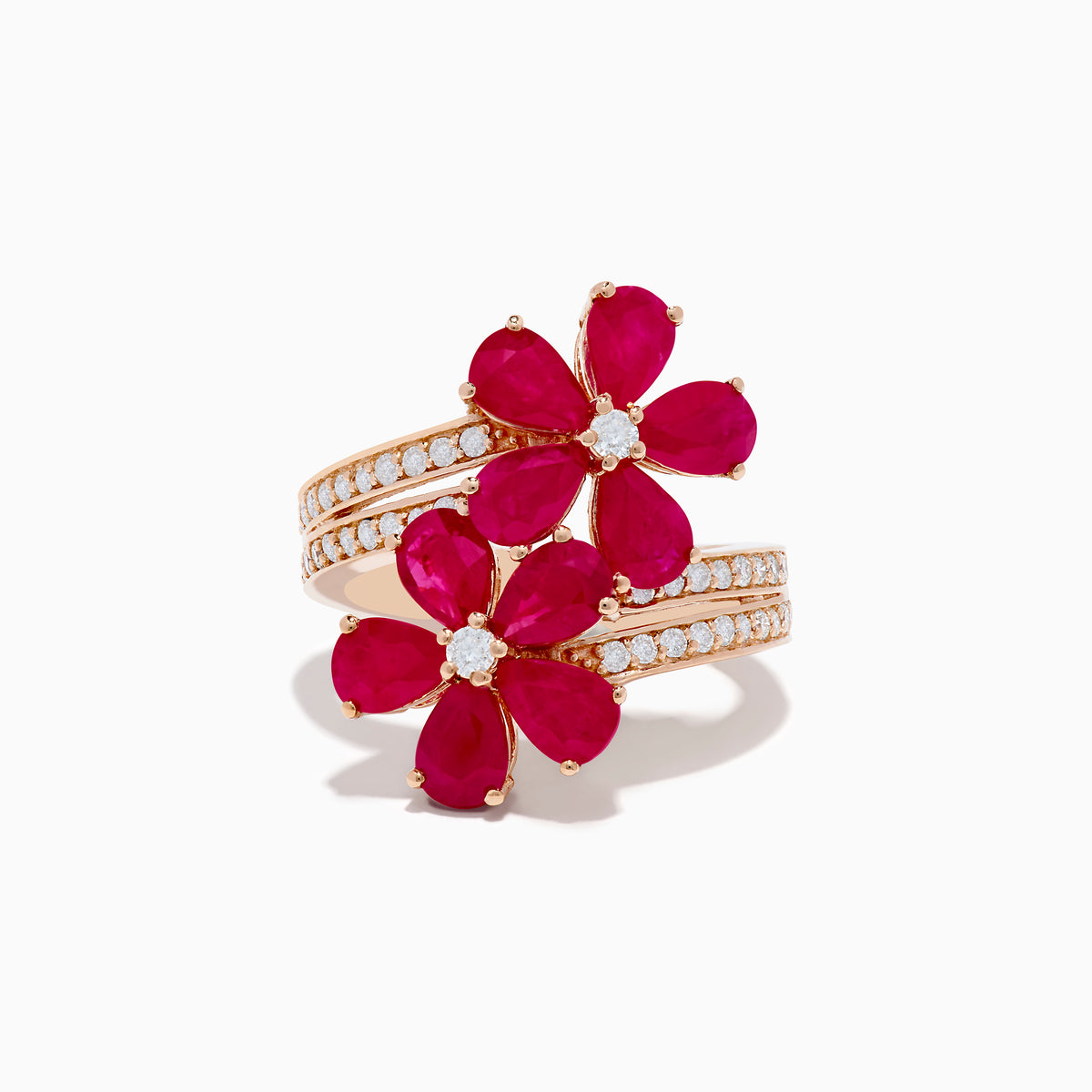 The Ruby Royale 14K Rose Gold Ruby and Diamond Floral Ring features two ruby flower motifs with diamond centers and a diamond-accented band, displayed on a white background.