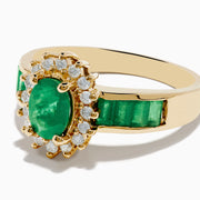 The Brasilica 14K Yellow Gold Emerald and Diamond Ring features an oval emerald center, sparkling diamonds, and elegant green inlays along the band.