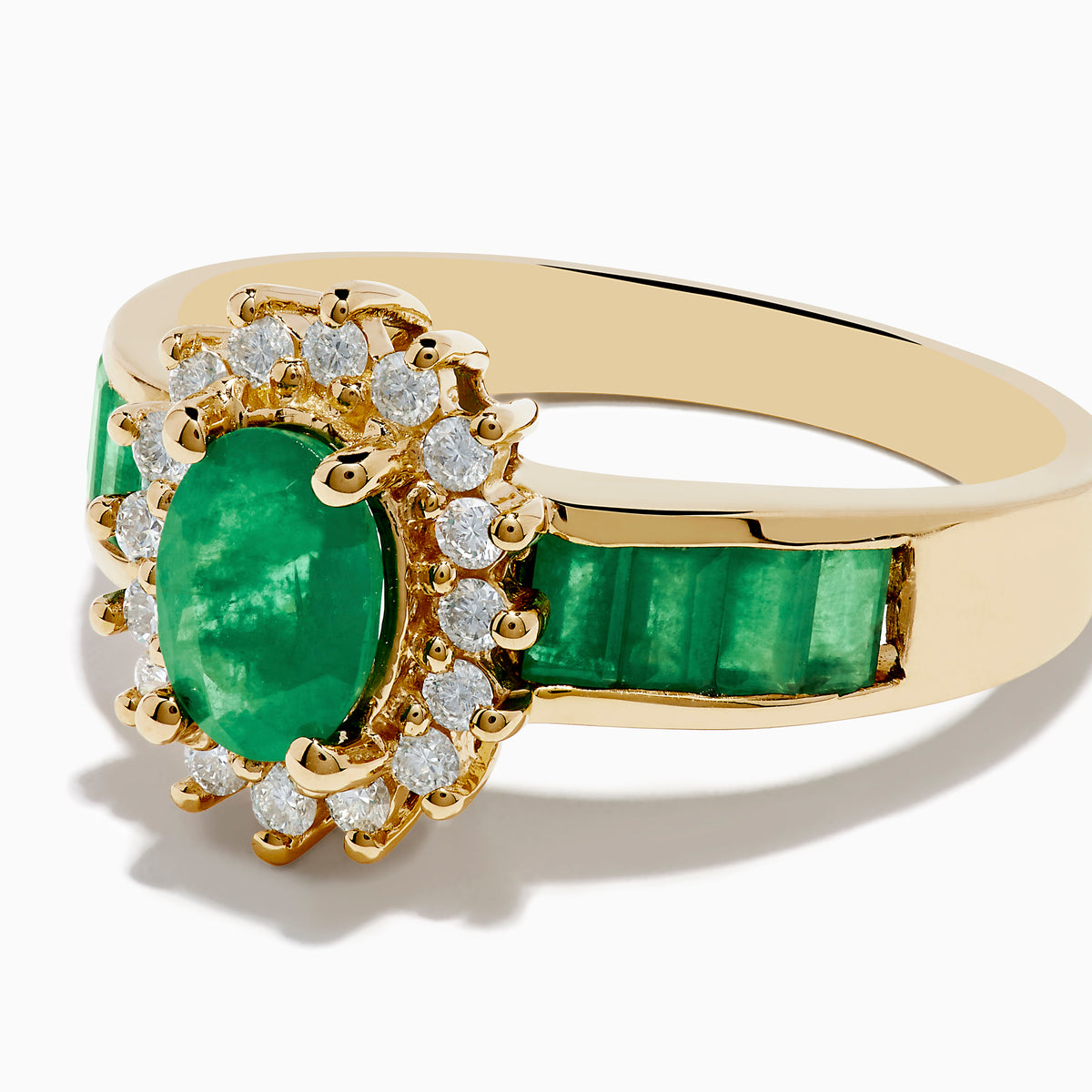 The Brasilica 14K Yellow Gold Emerald and Diamond Ring features an oval emerald center, sparkling diamonds, and elegant green inlays along the band.