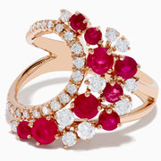 The Ruby Royale 14K Rose Gold Ruby and Diamond Wave Ring features a heart-shaped open design with clusters of round red rubies and sparkling white diamonds set along the band in elegant floral patterns.