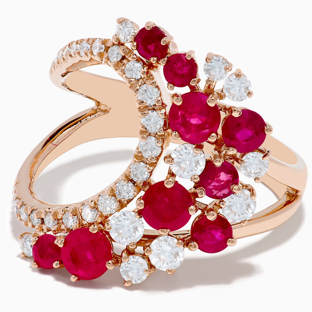 The Ruby Royale 14K Rose Gold Ruby and Diamond Wave Ring features a heart-shaped open design with clusters of round red rubies and sparkling white diamonds set along the band in elegant floral patterns.