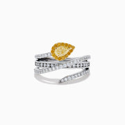 The 18K Two-Tone Gold White and Yellow Diamond Crossover Bypass Ring showcases overlapping diamond bands, a large pear-shaped yellow diamond at the center, and smaller yellow diamonds for a striking two-tone effect.