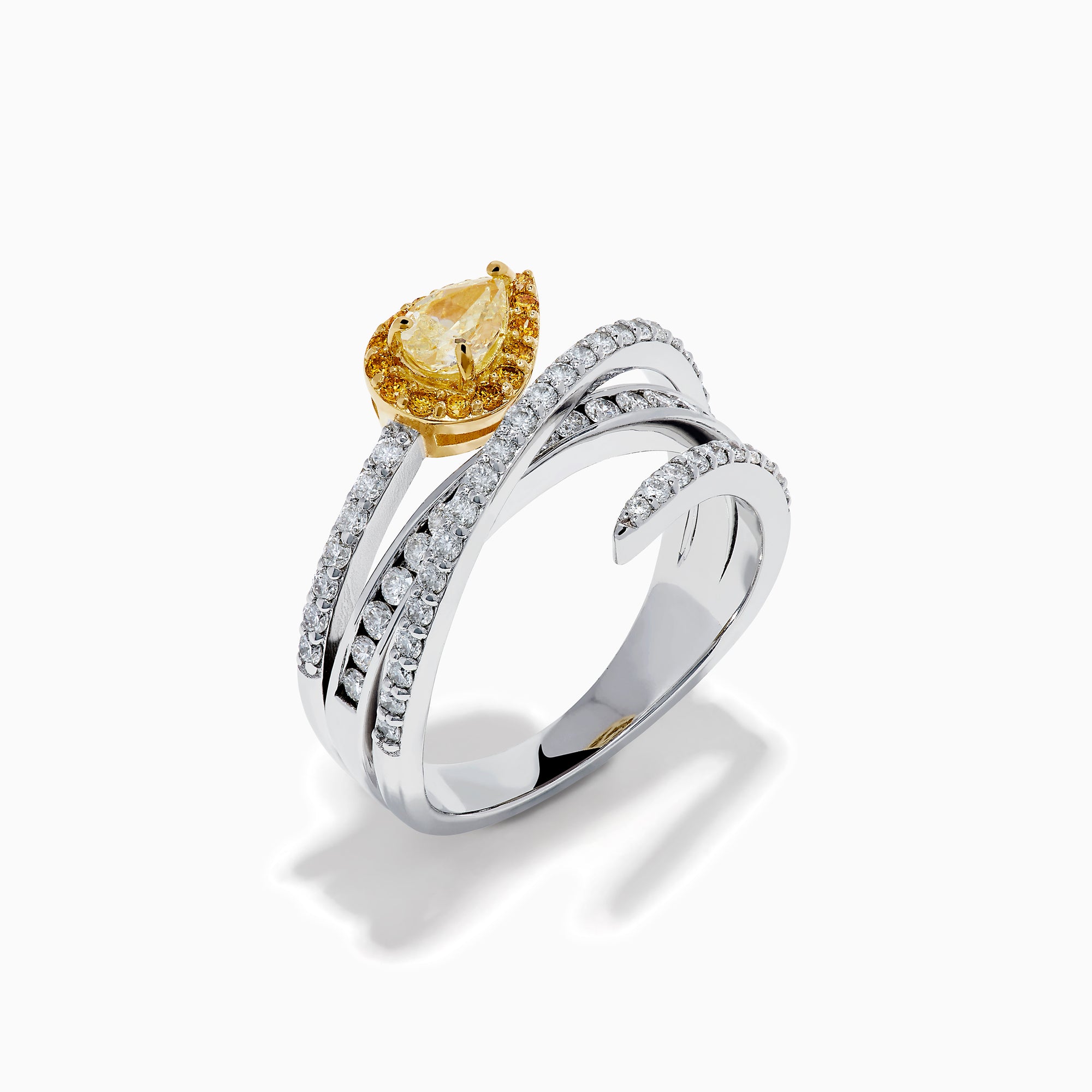 The 18K Two-Tone Gold White and Yellow Diamond Crossover Bypass Ring showcases overlapping diamond bands, a large pear-shaped yellow diamond at the center, and smaller yellow diamonds for a striking two-tone effect.