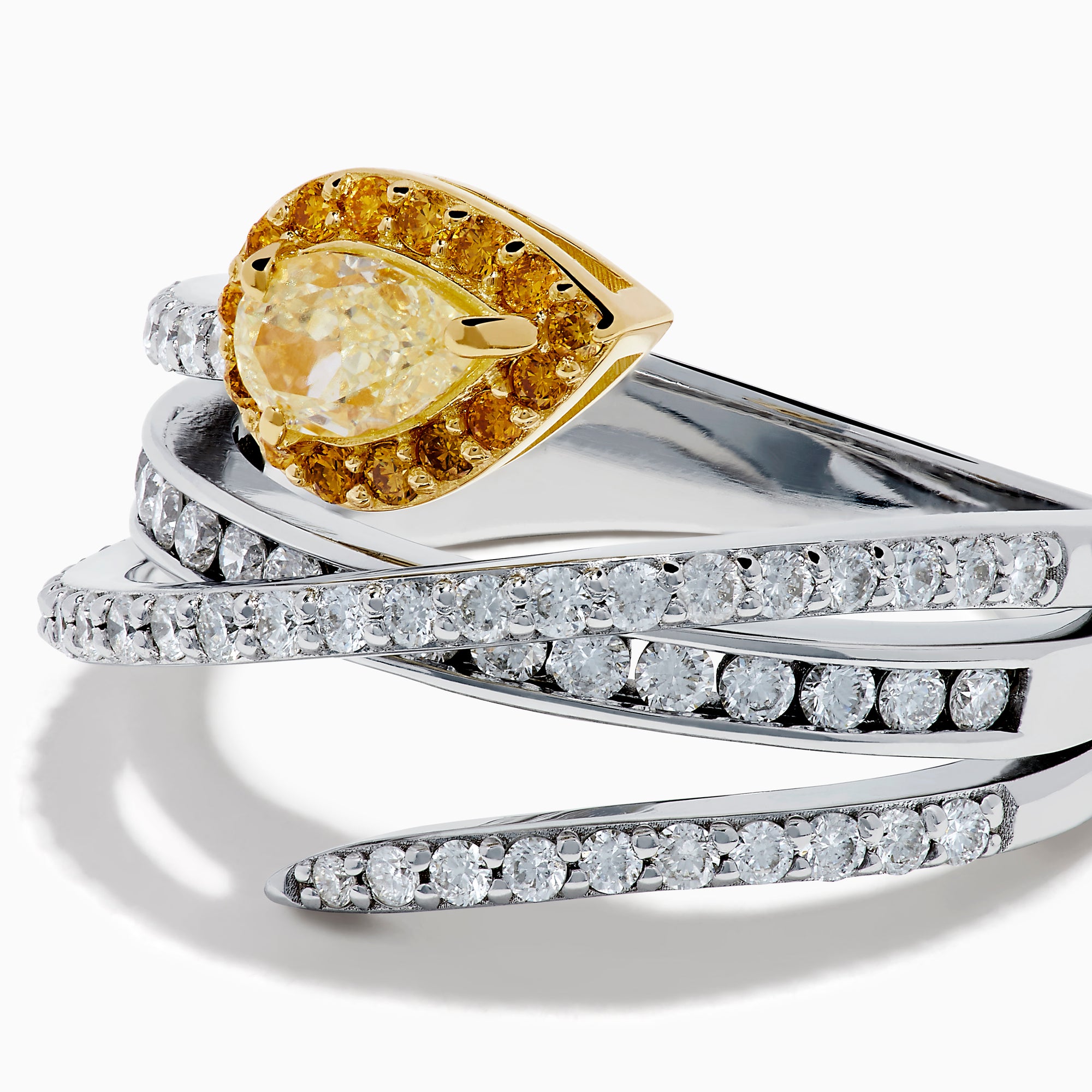 The 18K Two-Tone Gold White and Yellow Diamond Crossover Bypass Ring showcases overlapping diamond bands, a large pear-shaped yellow diamond at the center, and smaller yellow diamonds for a striking two-tone effect.