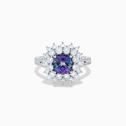 The 18K White Gold GIA Certified Zoisite and Diamond Ring features a cushion-cut blue-purple zoisite center stone with a starburst diamond halo, creating a striking look against the white gold setting.