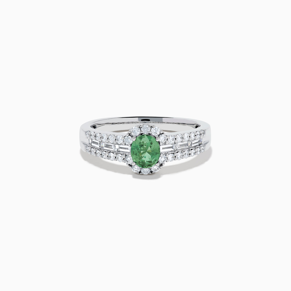 The 18K White Gold Alexandrite and Diamond Split Halo Ring showcases a central oval green Alexandrite, surrounded by a diamond halo with additional diamonds set along the band.