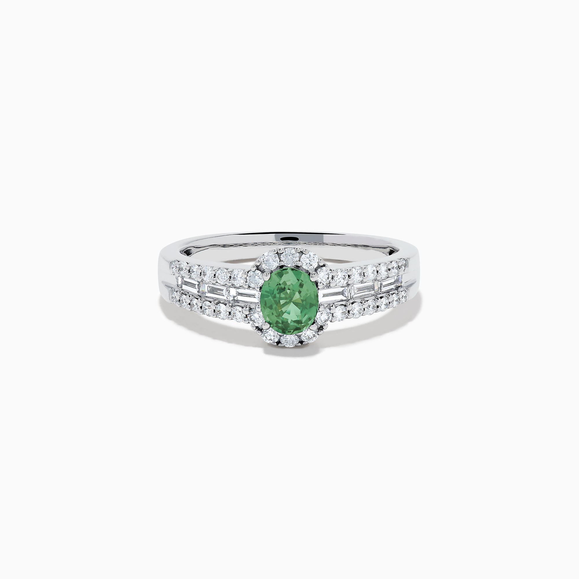 The 18K White Gold Alexandrite and Diamond Split Halo Ring showcases a central oval green Alexandrite, surrounded by a diamond halo with additional diamonds set along the band.