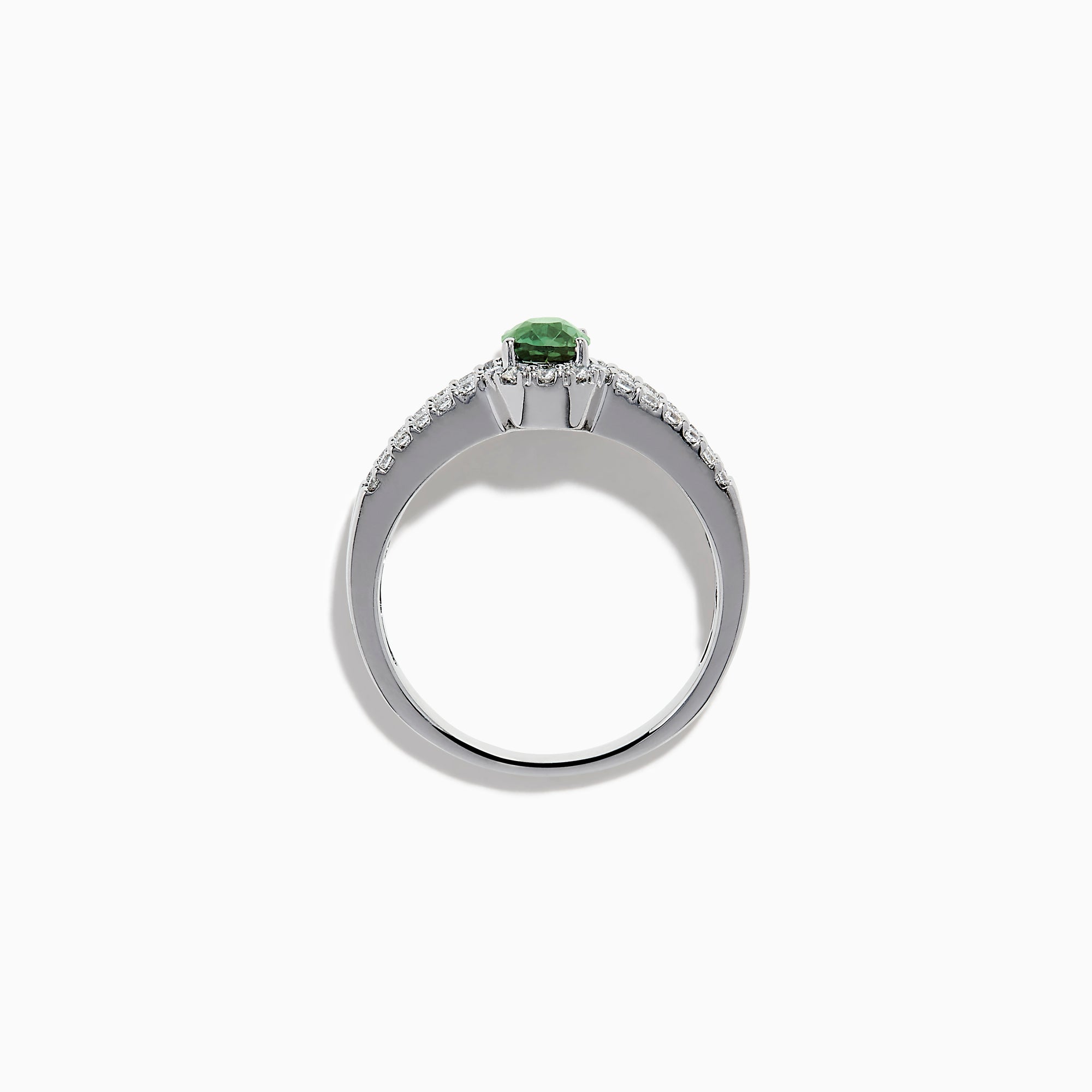 The 18K White Gold Alexandrite and Diamond Split Halo Ring showcases a central oval green Alexandrite, surrounded by a diamond halo with additional diamonds set along the band.