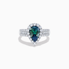 The 18K White Gold GIA Certified Pear Zoisite and Diamond Ring showcases a striking blue-green gemstone accented by round diamonds, with more diamonds along the band for extra brilliance and certified authenticity.