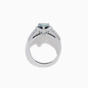 The 18K White Gold GIA Certified Pear Zoisite and Diamond Ring showcases a striking blue-green gemstone accented by round diamonds, with more diamonds along the band for extra brilliance and certified authenticity.