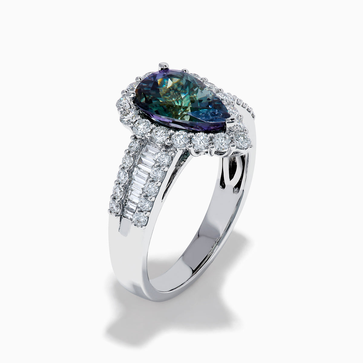 The 18K White Gold GIA Certified Pear Zoisite and Diamond Ring showcases a striking blue-green gemstone accented by round diamonds, with more diamonds along the band for extra brilliance and certified authenticity.