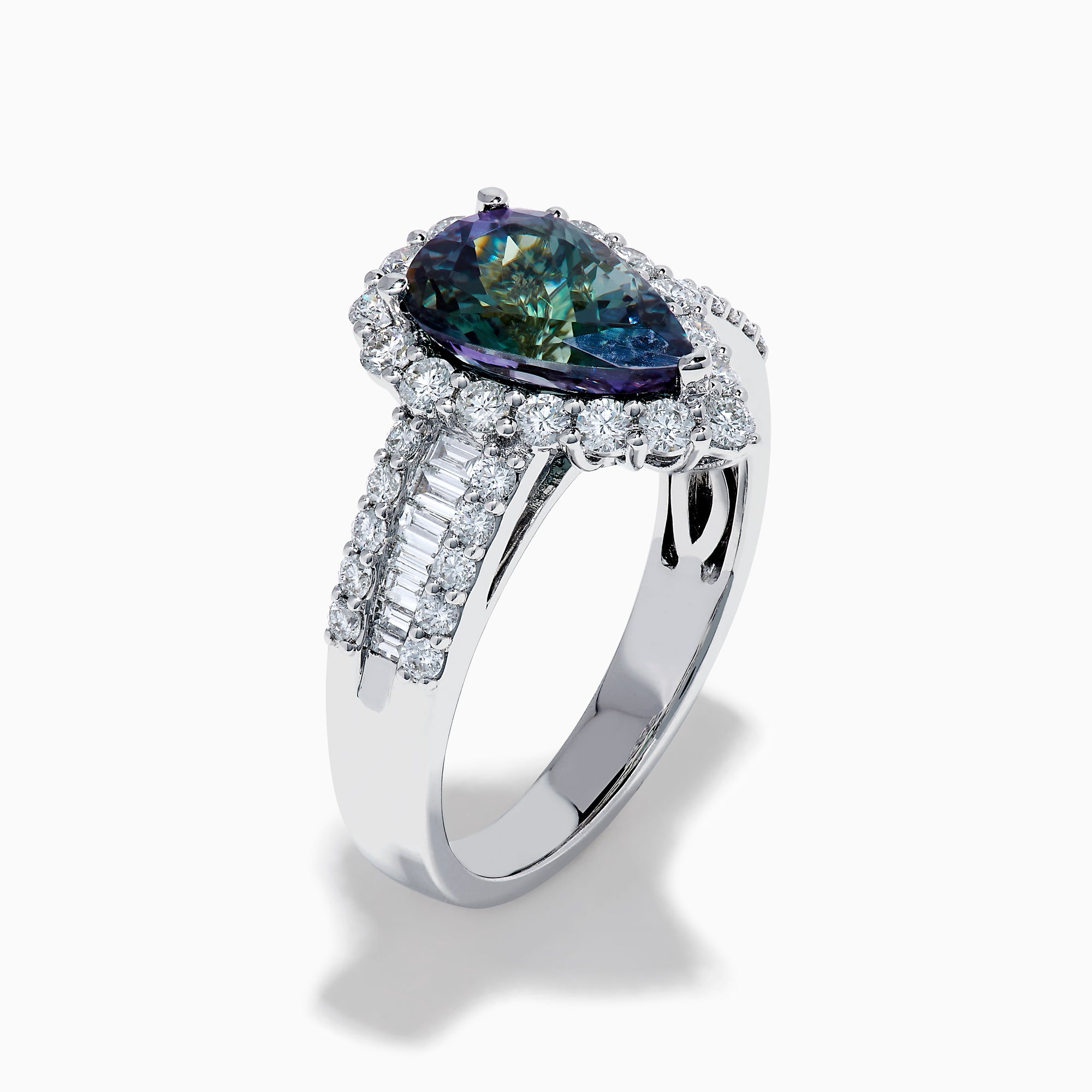 The 18K White Gold GIA Certified Pear Zoisite and Diamond Ring showcases a striking blue-green gemstone accented by round diamonds, with more diamonds along the band for extra brilliance and certified authenticity.