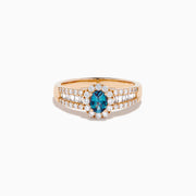 The 18K Rose Gold IGI Certified Alexandrite and Diamond Ring features an oval alexandrite center, a halo of white diamonds, and diamond-accented rows along the band.