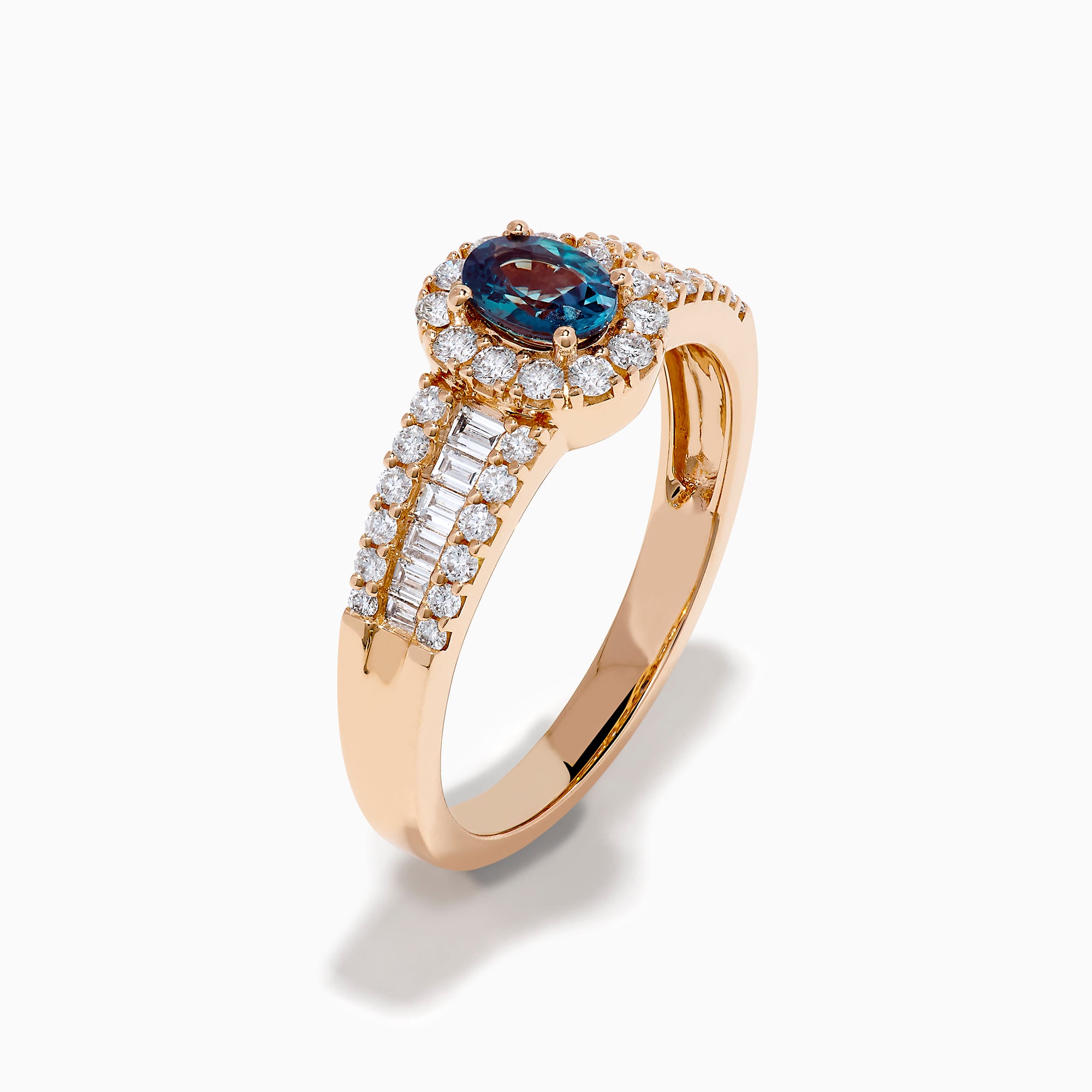 The 18K Rose Gold IGI Certified Alexandrite and Diamond Ring features an oval alexandrite center, a halo of white diamonds, and diamond-accented rows along the band.