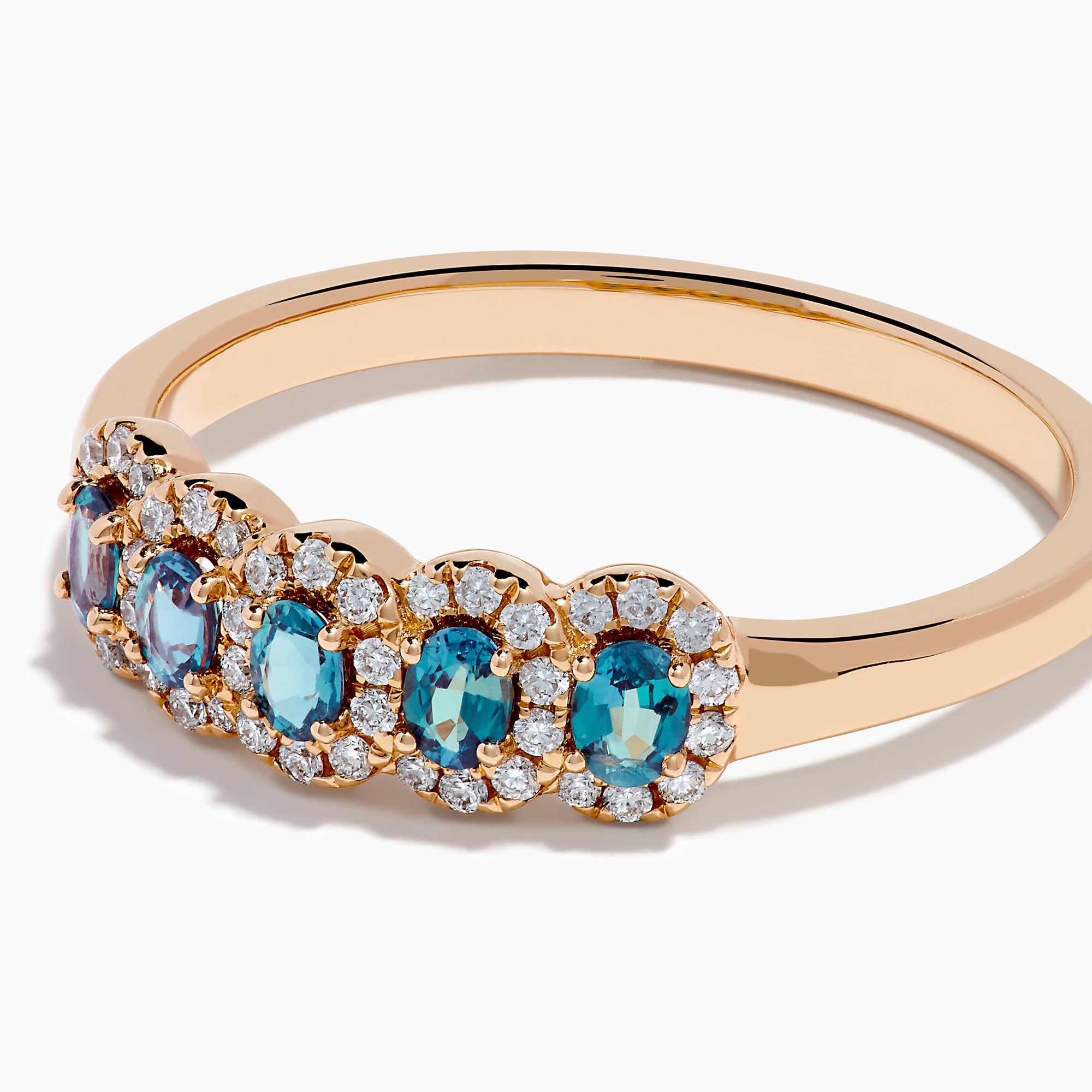The 18K Rose Gold Alexandrite and Diamond Ring features five oval alexandrites, each encircled by sparkling white diamonds, showcased against a white background.