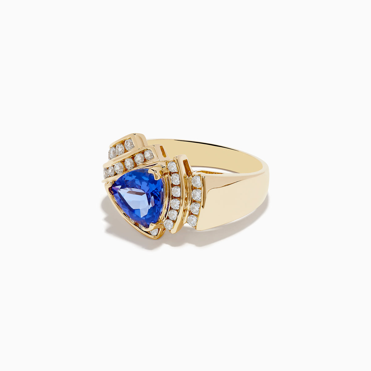 The Nahla Siri 14K Yellow Gold Tanzanite and Diamond Ring showcases a pear-shaped blue tanzanite center, accented by rows of sparkling diamonds set in an elegant, intricate gold band.