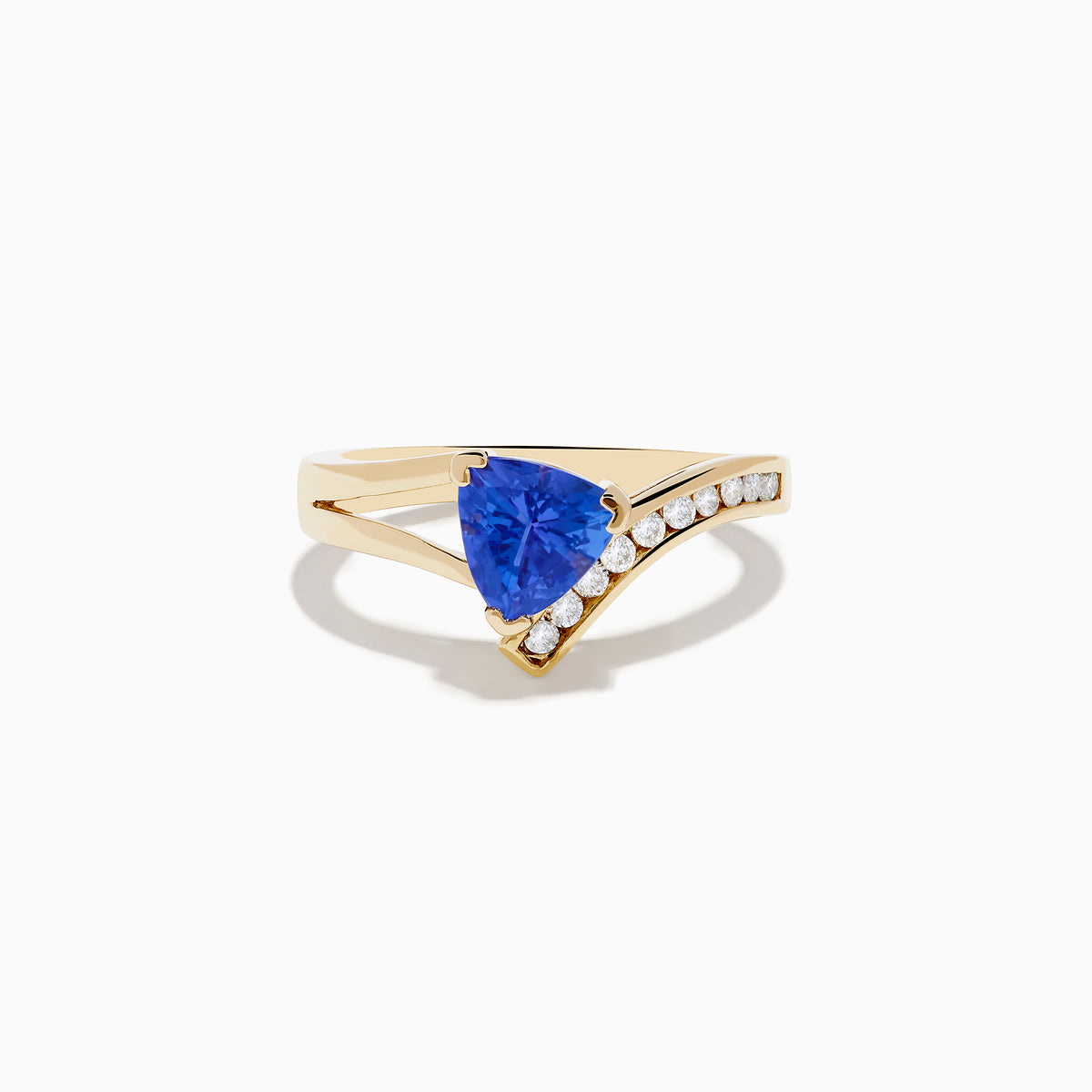 The Nahla 14K Yellow Gold Tanzanite and Diamond Ring features a triangular blue tanzanite center, accented by a curved row of sparkling round white diamonds on one side of the band.