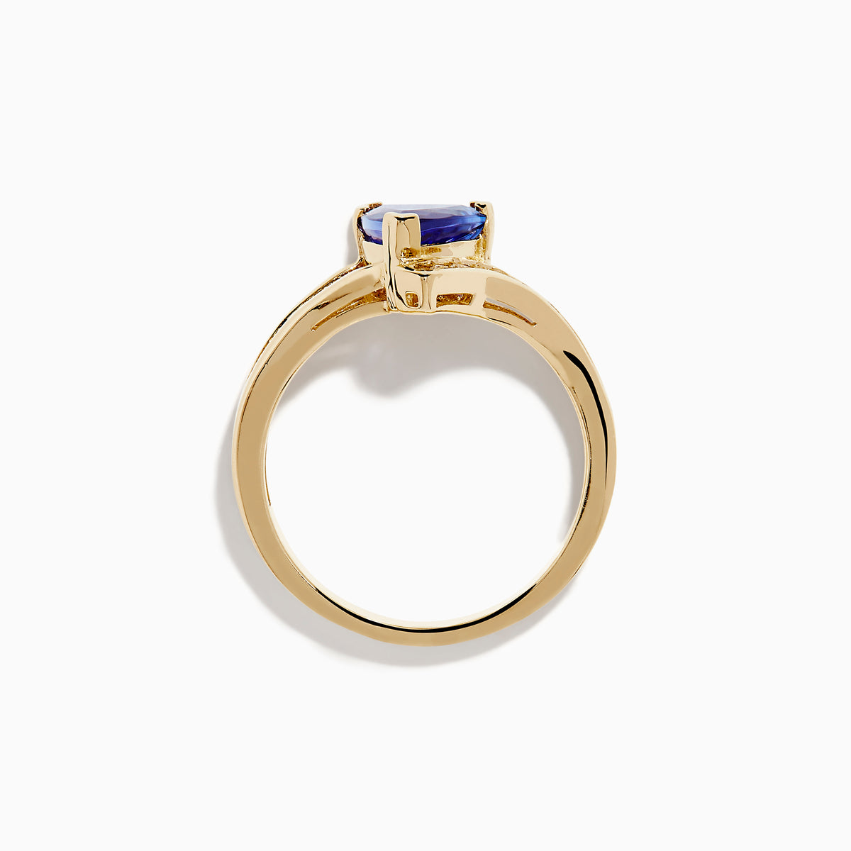 The Nahla 14K Yellow Gold Tanzanite and Diamond Ring features a triangular blue tanzanite center, accented by a curved row of sparkling round white diamonds on one side of the band.