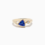 The Nahla Siri 14K Yellow Gold Tanzanite and Diamond Ring features a triangular blue tanzanite and a small round diamond, shown on a plain white background.
