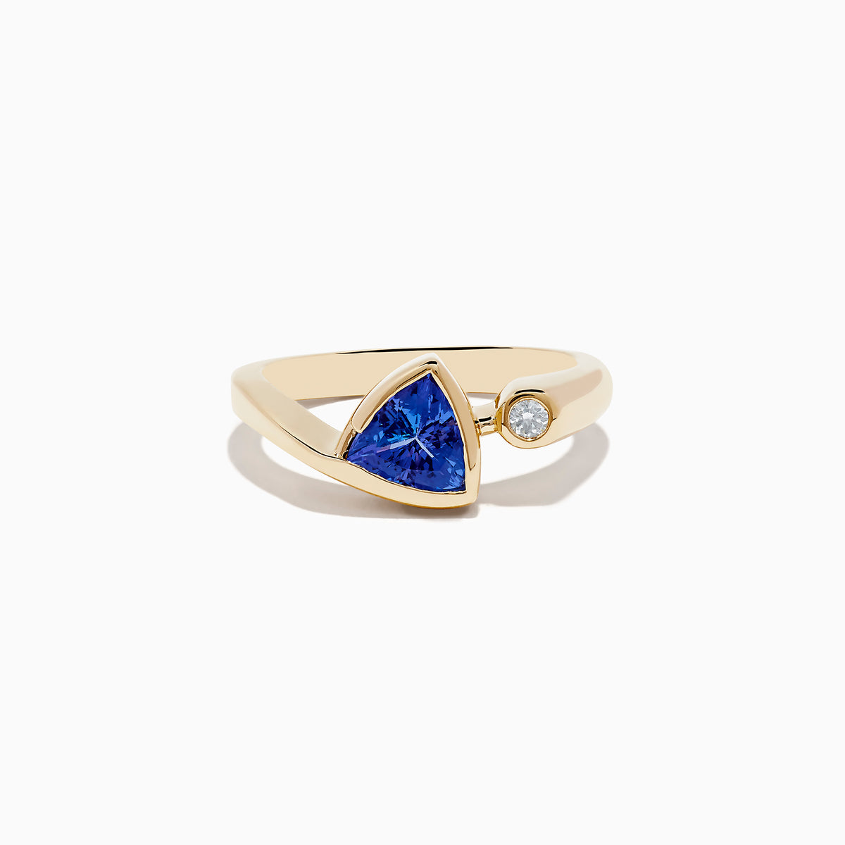 The Nahla Siri 14K Yellow Gold Tanzanite and Diamond Ring features a triangular blue tanzanite and a small round diamond, shown on a plain white background.