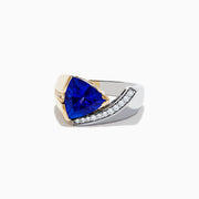 The Nahla Siri 14K Two-Tone Gold Tanzanite and Diamond Ring showcases a striking triangular blue tanzanite accented by a curved row of sparkling white diamonds on one side.