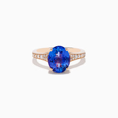The Nahla 14K Rose Gold Tanzanite and Diamond Ring showcases an oval-cut blue tanzanite centerpiece accented by round diamonds on the band, set against a white background.