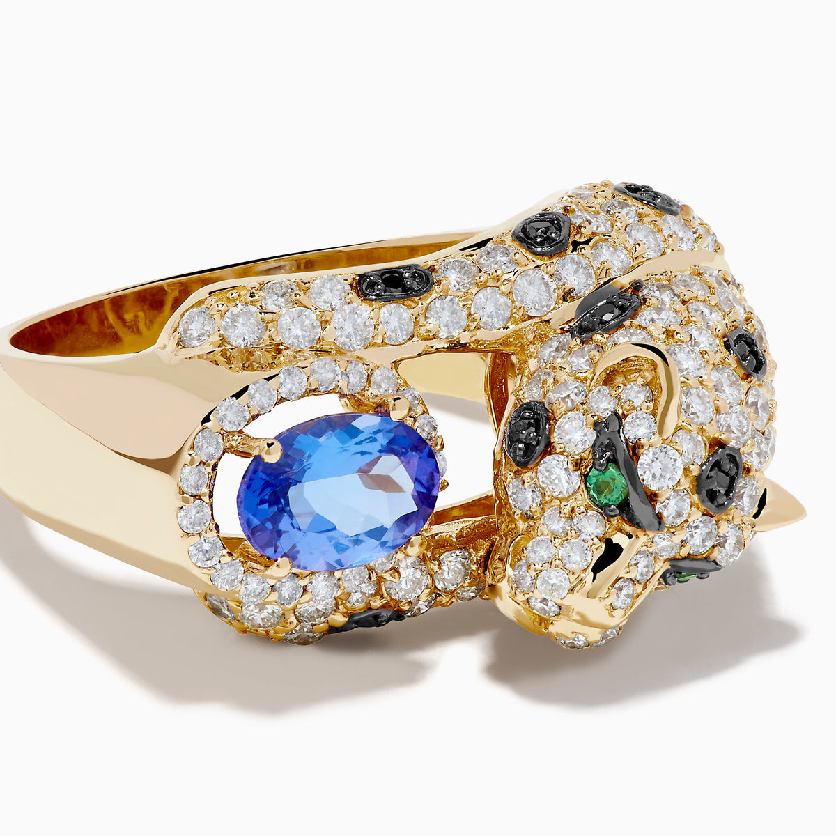 The Signature 14K Yellow Gold Tanzanite and Diamond Panther Ring showcases a sculpted panther with green gemstone eyes, diamond and black stone accents, holding an oval tanzanite gemstone.