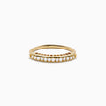 The 14K Yellow Gold Flexible Size 7-10 Diamond Ring showcases a row of round white diamonds set along the top half on a plain white background, with an adjustable fit for comfort.