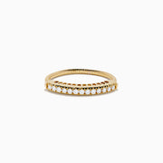 The 14K Yellow Gold Flexible Size 7-10 Diamond Ring showcases a row of round white diamonds set along the top half on a plain white background, with an adjustable fit for comfort.