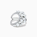 The 14K White Gold Diamond Wave Ring features an open curved design with clusters of round diamonds and marquise-shaped stones, set against a plain white background.
