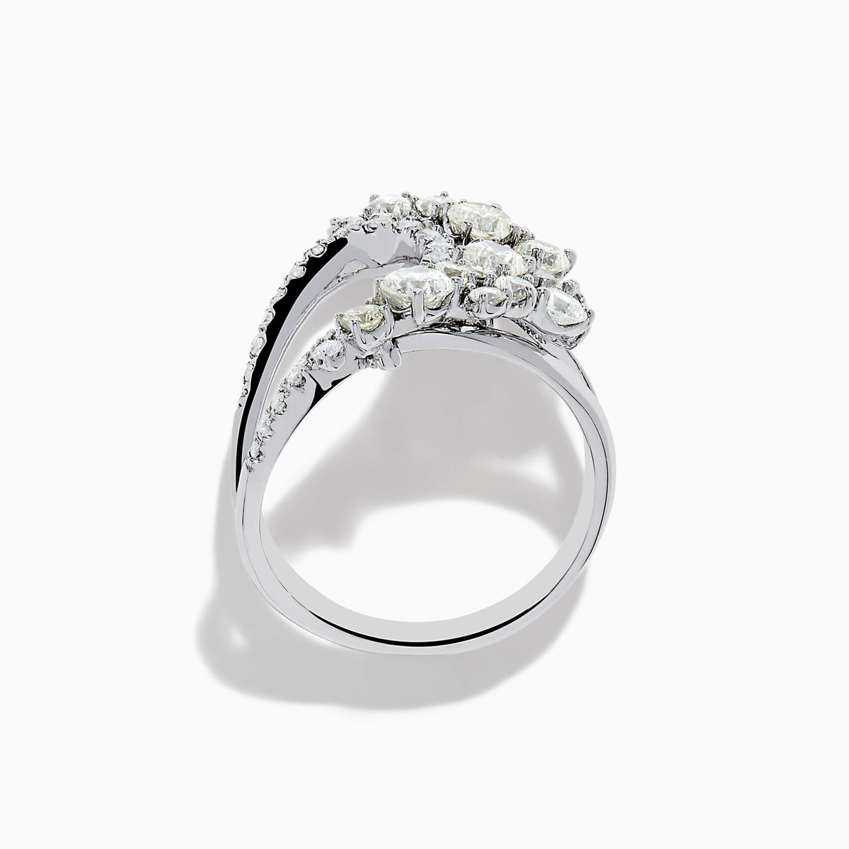 The 14K White Gold Diamond Wave Ring features an open curved design with clusters of round diamonds and marquise-shaped stones, set against a plain white background.