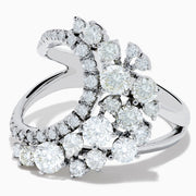 The 14K White Gold Diamond Wave Ring features an open curved design with clusters of round diamonds and marquise-shaped stones, set against a plain white background.