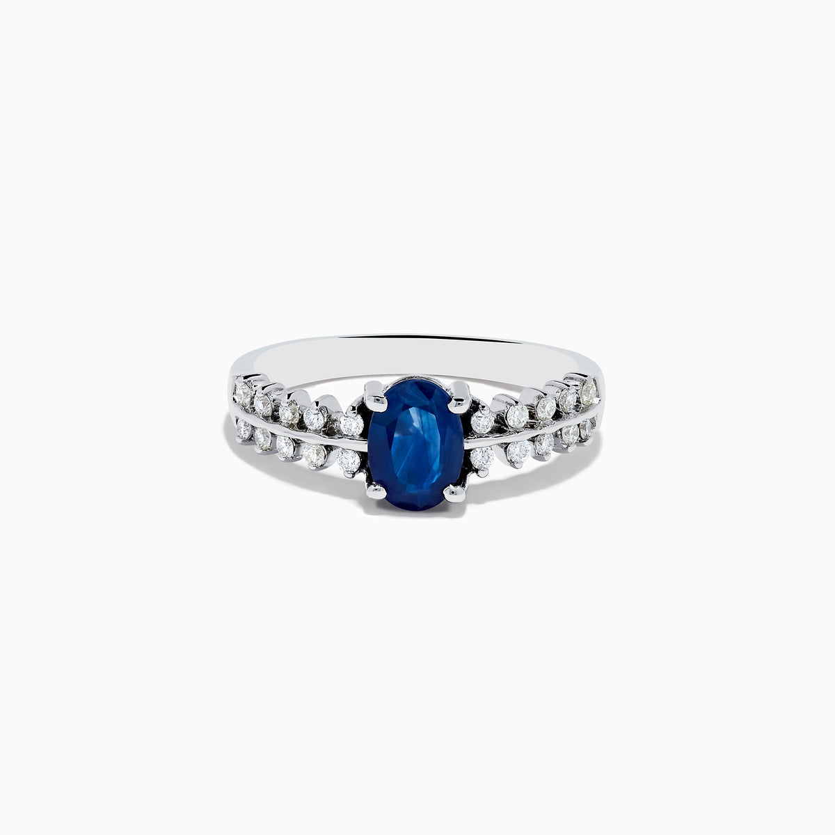The 14K White Gold Blue Sapphire and Diamond Ring showcases an oval blue sapphire center, accented by two rows of round diamonds on each side, elegantly set against a white background.