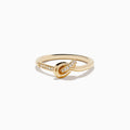 The Doro 14K Yellow Gold Diamond Knot Ring features a central knot design with one side of the band accented by sparkling diamonds, shown on a white background.