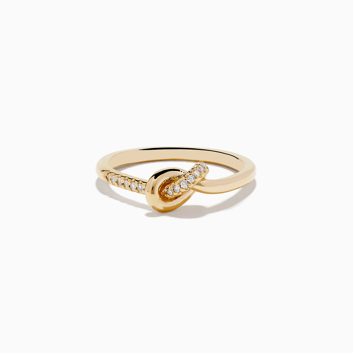 The Doro 14K Yellow Gold Diamond Knot Ring features a central knot design with one side of the band accented by sparkling diamonds, shown on a white background.