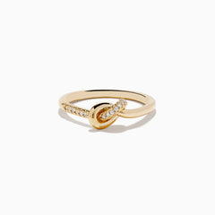 The Doro 14K Yellow Gold Diamond Knot Ring features a central knot design with one side of the band accented by sparkling diamonds, shown on a white background.