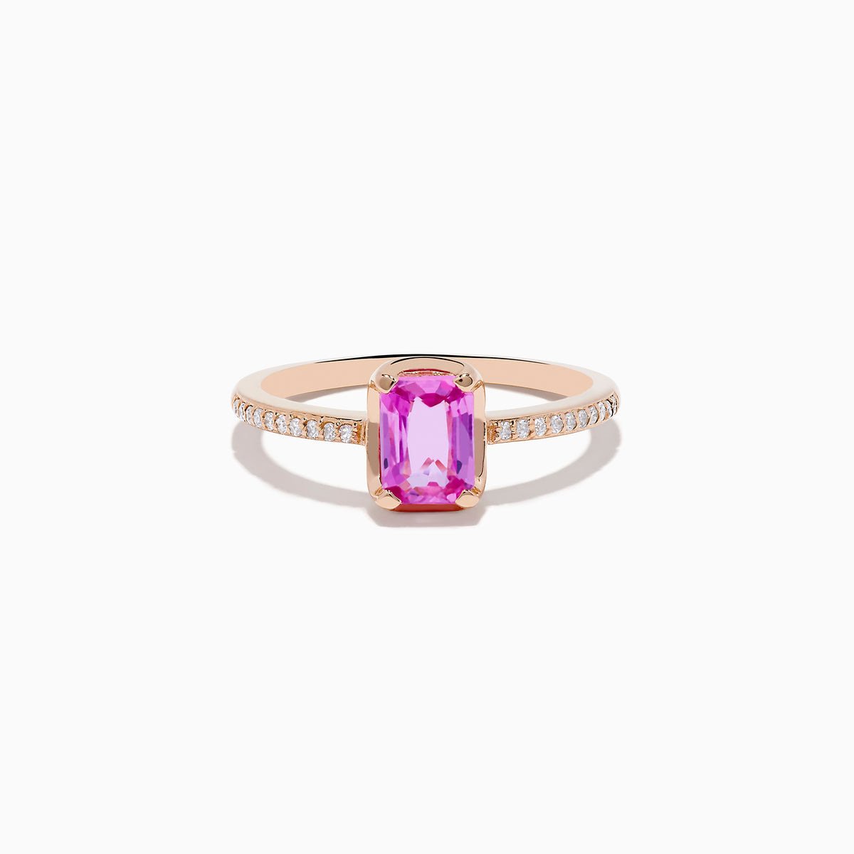 The 14K Rose Gold Pink Sapphire and Diamond Solitaire Ring features a rectangular pink sapphire centerpiece and small round diamonds on the band, shown against a white background.