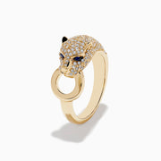 The Signature 14K Yellow Gold Sapphire and Diamond Panther Ring showcases a diamond-encrusted panther head with sapphire eyes, holding a gold loop in its mouth against a white background.