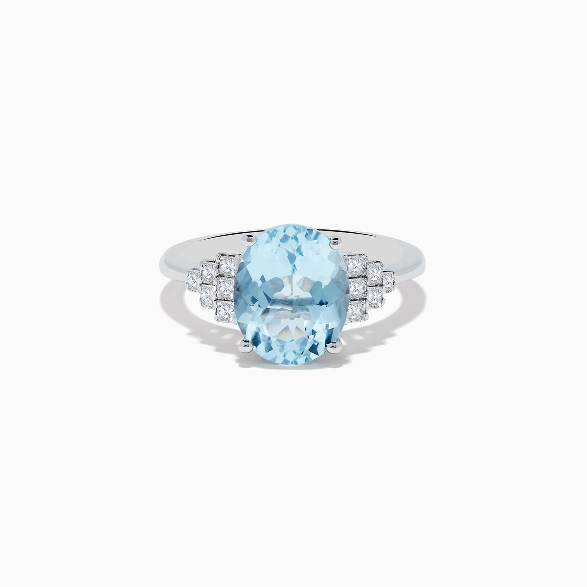 The Aquarius 14K White Gold Aquamarine and Diamond Ring showcases a large oval aquamarine center stone, accented by three rows of round diamonds on each side against a white gold setting.