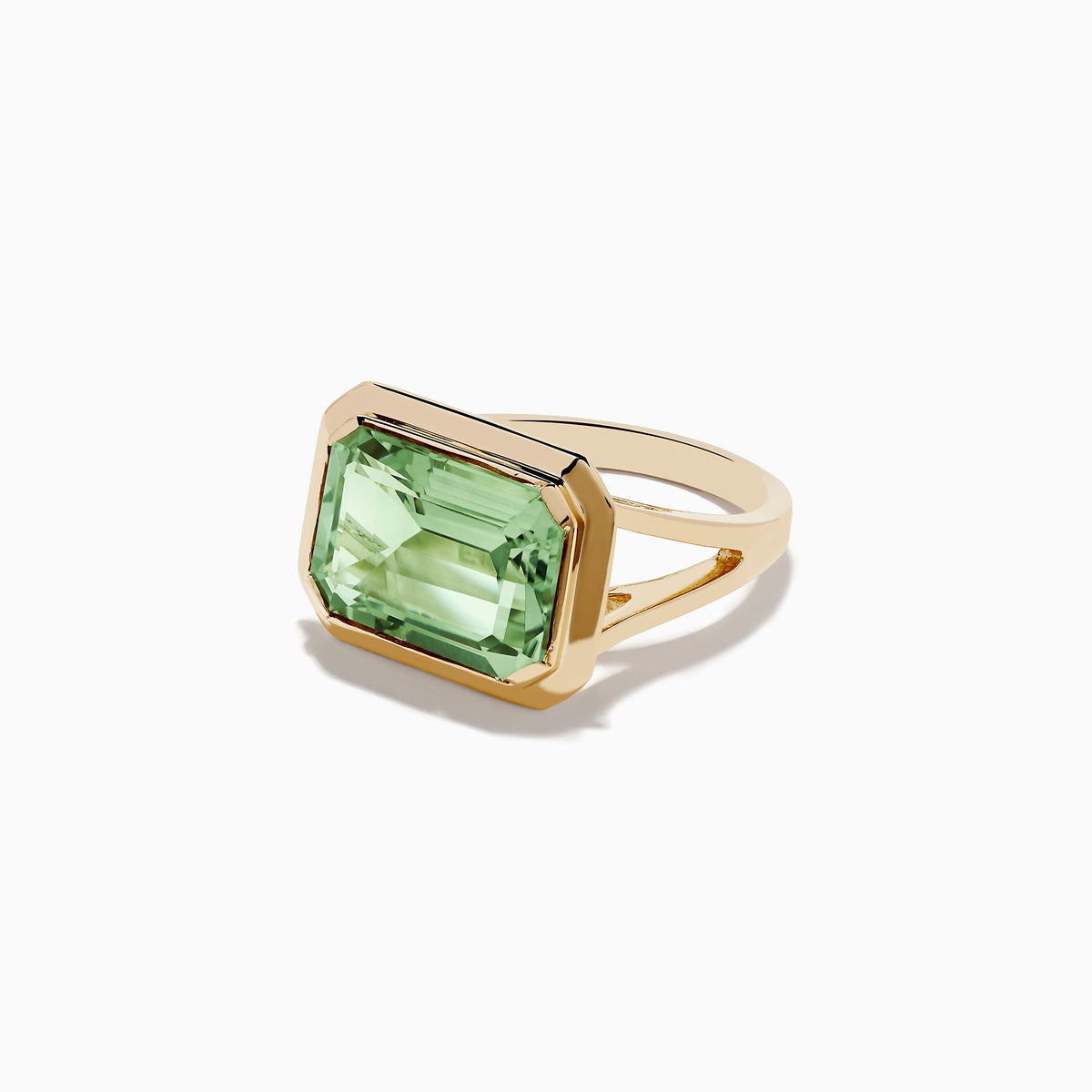 The 14K Yellow Gold Green Amethyst Ring features a striking emerald-cut gemstone in a simple, thick gold band, showcased on a white background.