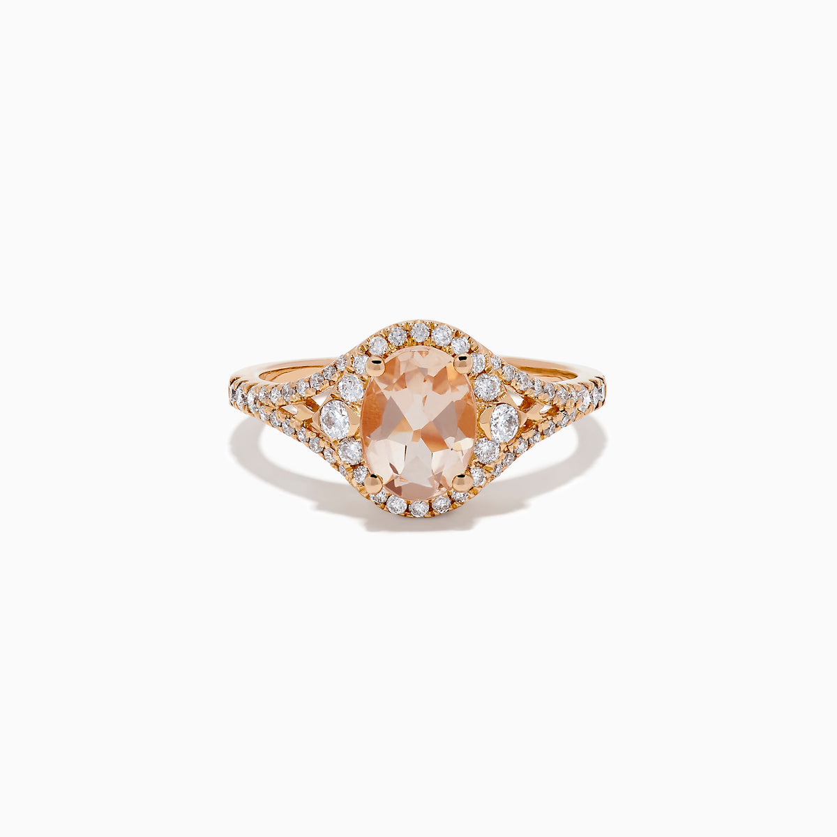 The Rose Gold Morganite and Diamond Split Halo Ring showcases an oval peach-colored Morganite center, encircled by a sparkling diamond split halo with additional diamonds along the band.