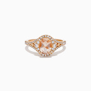 The Rose Gold Morganite and Diamond Split Halo Ring showcases an oval peach-colored Morganite center, encircled by a sparkling diamond split halo with additional diamonds along the band.