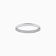 Displayed on a plain white background, the 14K White Gold Pave Diamond Band 0.14 TCW features a single row of small, sparkling diamonds set along the top half of its slim band.