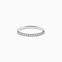 Displayed on a plain white background, the 14K White Gold Pave Diamond Band 0.14 TCW features a single row of small, sparkling diamonds set along the top half of its slim band.